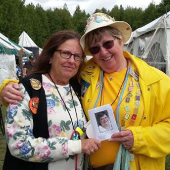 two women holding memorial photo