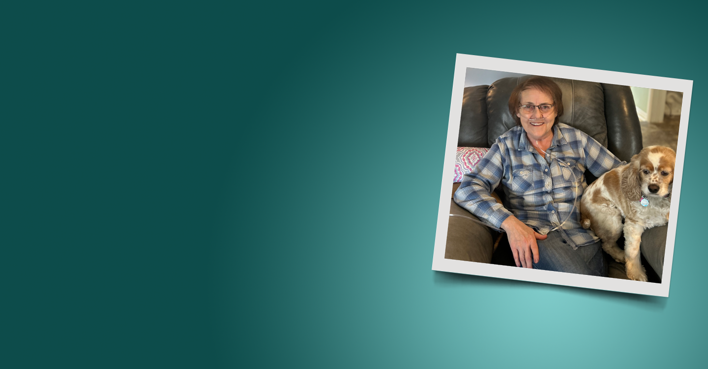 Woman sitting in chair with her dog a cocker spaniel