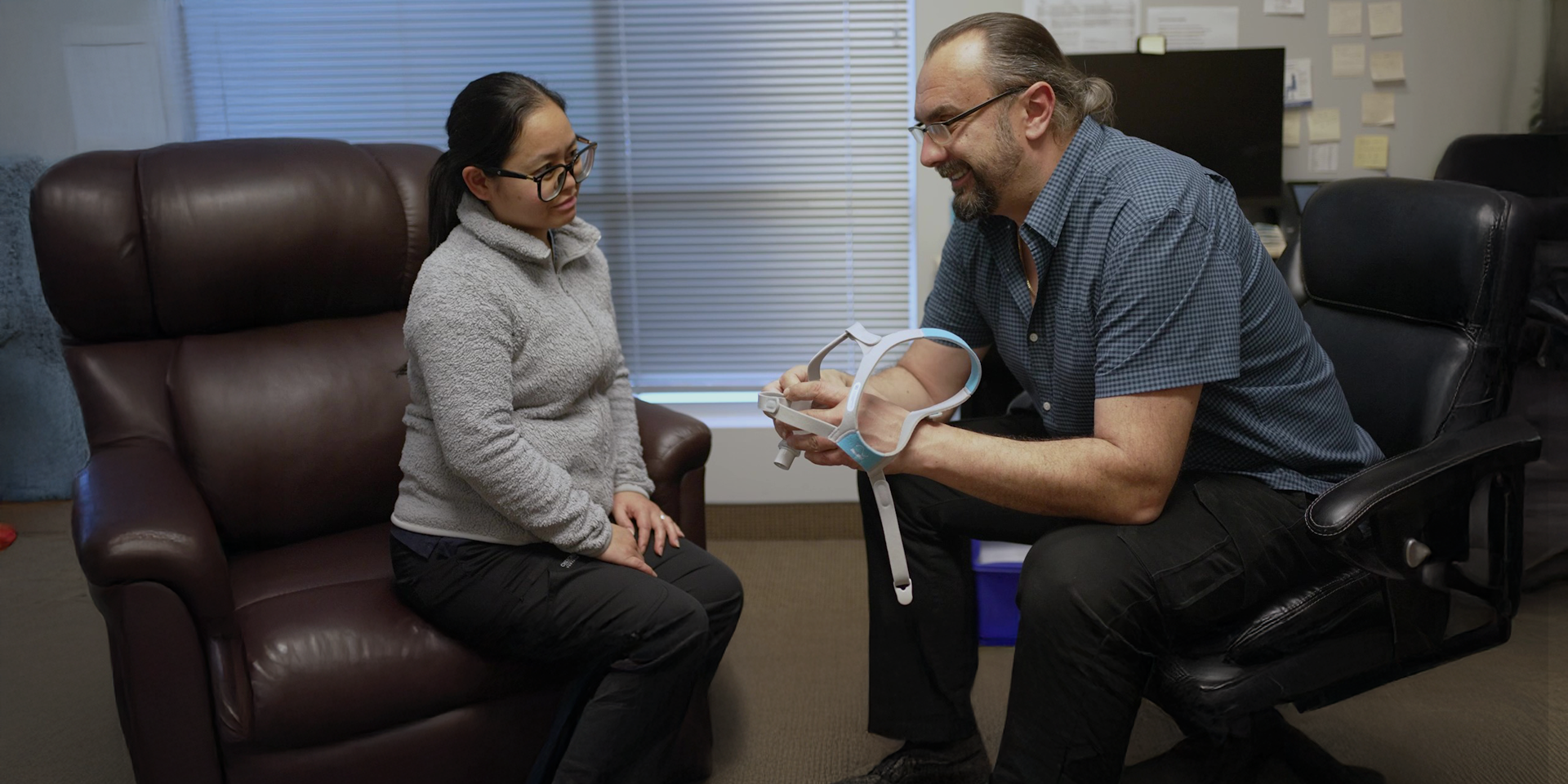 ProResp Employee showing paient a CPAP mask