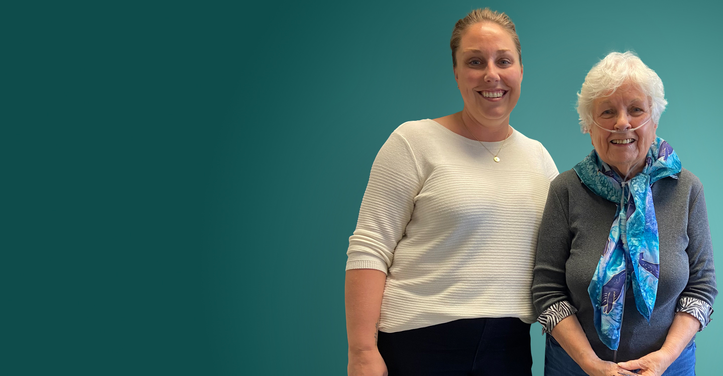two women standing together one wearing oxygen