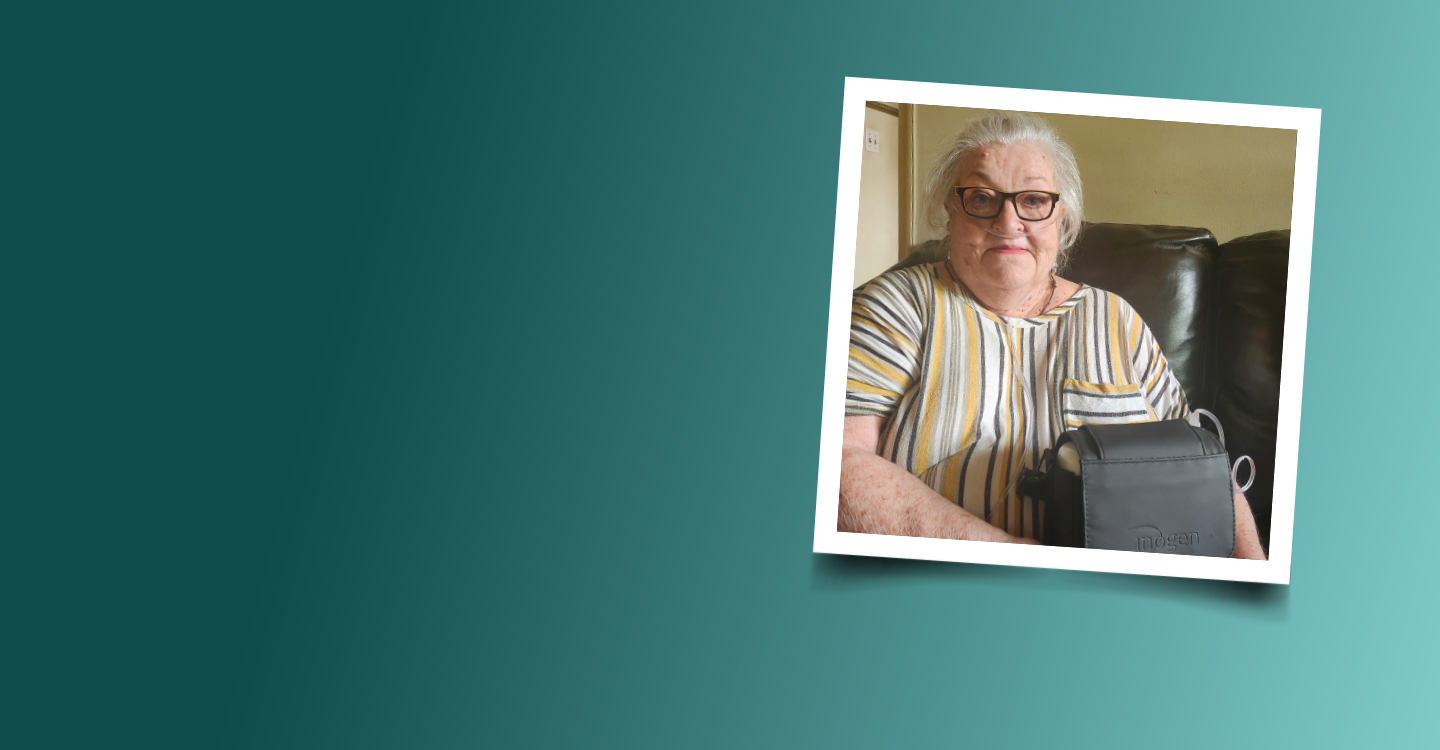 Photo of a senior woman wearing Oxygen holding a portable oxygen device