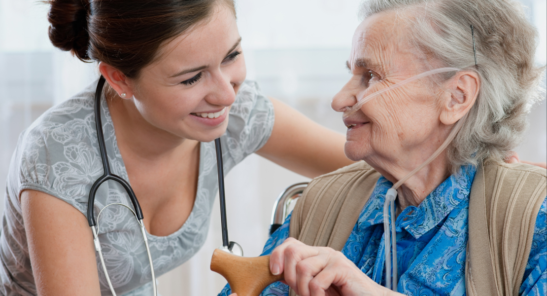 A caregiver helping an elderly patient.